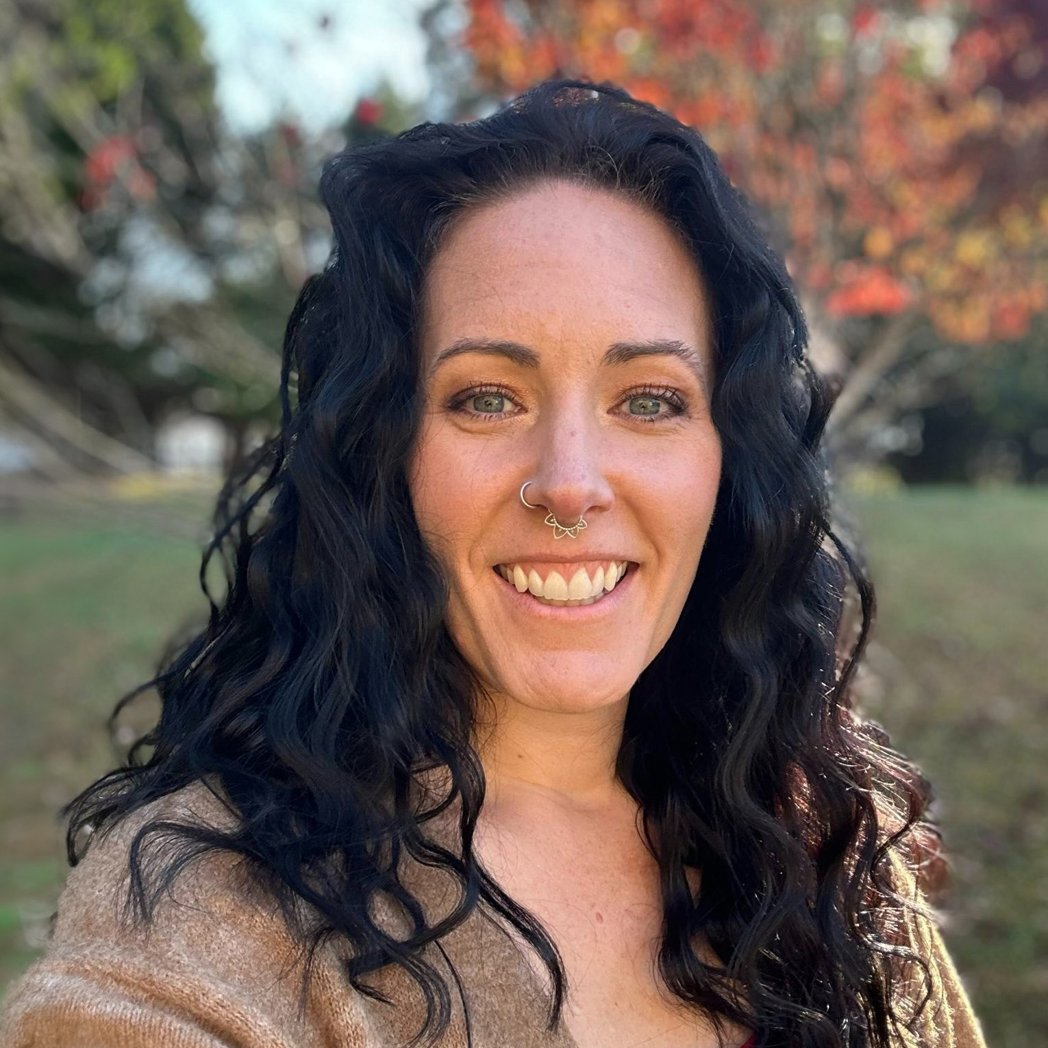 Kathleen Pinkston smiling outdoors with long dark hair